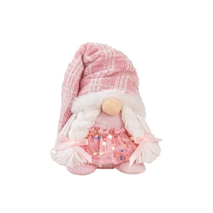 Pink Christmas gnome doll with sequins dress and white braids on white background