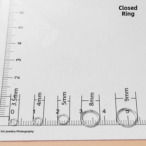 Close-up of s925 silver jump rings in 3.5mm to 9mm sizes on a measurement scale