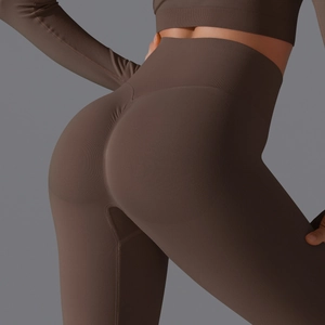 Close-up of high-waist scrunch butt seamless yoga pants in deep brown ribbed knit