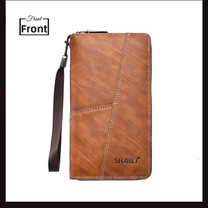 Front view of brown leather long wallet featuring zipper and wrist strap detail