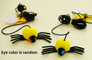 Detail of plush spider cat toys with elastic ropes, metal bells, and suction cups