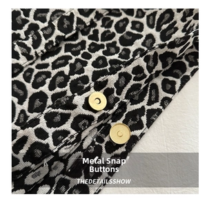 Detail shot of the high-quality golden magnetic snaps on the leopard print nylon tote bag