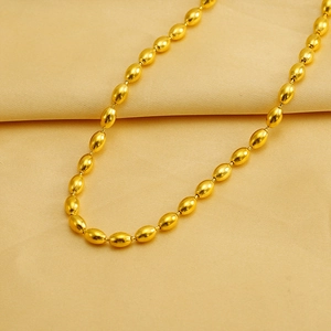 Elegant gold oval bead chain necklace with mirror finish on a soft silk background