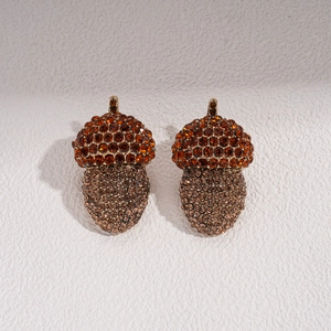 Close-up of acorn pendants featuring detailed amber and champagne crystal rhinestones