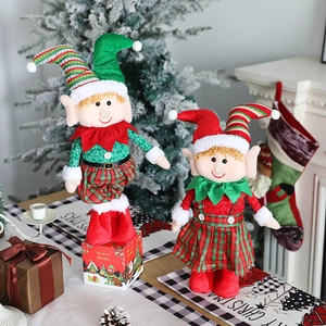 Adorable Christmas elf dolls with telescopic legs placed by a festive fireplace
