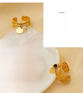 Detail of 18K gold-plated multi-layer stainless steel ring with stone and charm charms