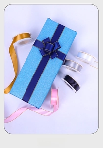 Detailed view of 2cm satin ribbons with gold edges in various colors for gift wrapping