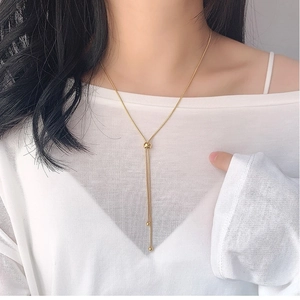 Adjustable Y-shaped lariat necklace in rose gold finish with sliding gold bead charm