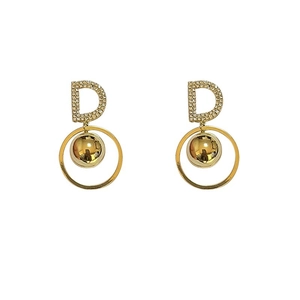Golden earrings with D letter zircon pendant and polished metal spheres in a minimalist style