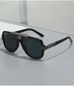 Detail of pilot square sunglasses with black frame and sleek silver metal bridge accents