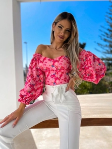Detailed close-up of pink floral off-shoulder blouse with elegant puff sleeves design