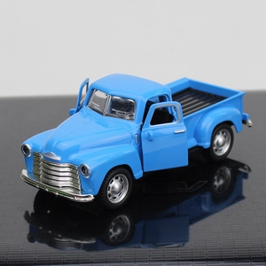 Detailed macro view of a blue vintage alloy pickup truck model with openable doors
