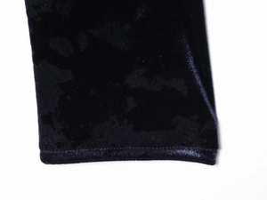 Macro view showing the soft black velvet fabric texture and neat stitching details