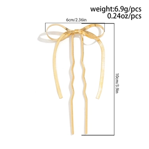 Detailed view of golden metal bow hair pin with size markers 6cm width and 10cm length
