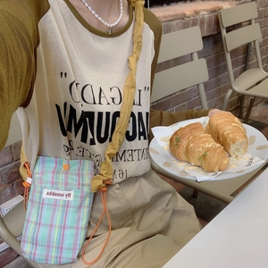 Chic checkered drawstring crossbody bag for women in colorful pastel fabric and orange strap