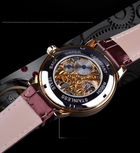 Close-up of skeleton mechanical watch back showing the transparent movement and engraving