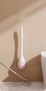 Wall-mounted long handle toilet brush with pink drop-shaped base for modern bathroom decor