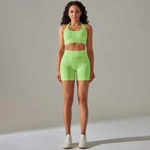 Close-up of ribbed texture on neon green seamless yoga bra and high waist shorts
