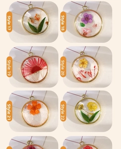 Detailed view of assorted handmade resin charms with real dried flowers and gold alloy frames