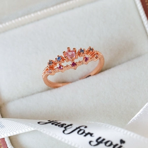 Macro shot of rose gold crown ring with colorful zircon gems in a luxury gift box
