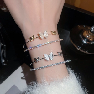 Detail of elegant butterfly zircon bracelets set with shimmering mother of pearl effect