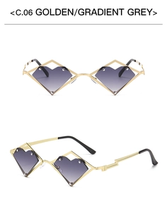 Detail of heart-shaped gold metal frame sunglasses with gradient grey lenses