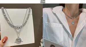 Close-up of double layer silver chain necklace with retro Good Luck coin pendant