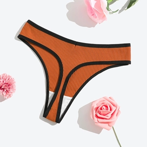 Detail of ribbed cotton thong in rust red with black trim and floral decor