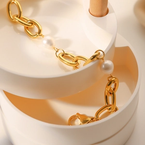 French vintage gold chain bracelet with freshwater pearls on a white jewelry organizer