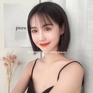 Close-up of elegant leaf-shaped tassel earrings with silver finish on a female model
