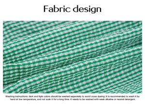 Close-up of green and white checkered textured fabric with detailed washing instructions