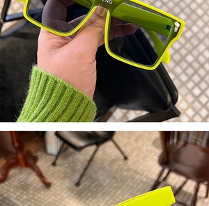 Detail of neon green square sunglasses featuring gradient lenses and frame engraving