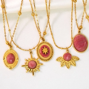 French vintage style gold necklaces with pink rhodochrosite pendants on white silk