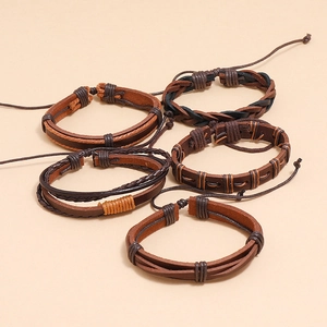 Close-up of a 5-piece set of woven brown leather bracelets with adjustable drawstring