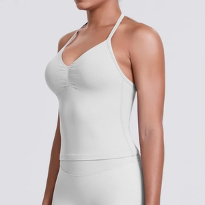 Side view detail of white halter sports bra and high waisted yoga leggings set