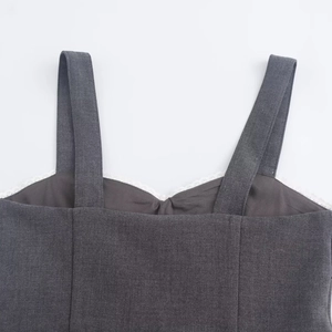 Close-up of dark grey lace trim neckline and textured fabric on backless dress