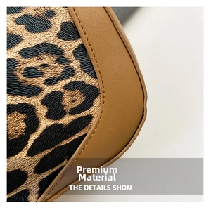Macro shot of leopard print fabric and brown pebble leather texture on a shoulder bag