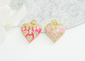 Detail of 18K gold-plated heart charms with pink enamel drip and sparkling zircon inlay