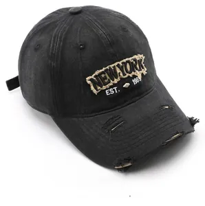 Detail of vintage washed cotton baseball cap with distressed embroidery and frayed edges