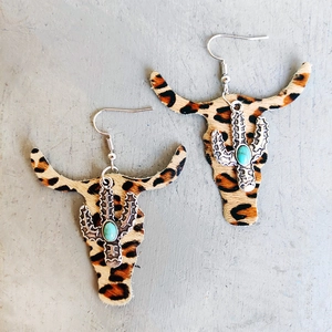 Detail of leather leopard print bull head earrings with cactus and turquoise stone