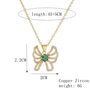 Macro view of gold plated hollow butterfly pendant with zircon inlay and dimensions