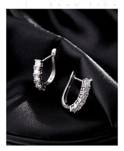 Macro shot of S925 sterling silver hoop earrings with clear pave moissanite stones