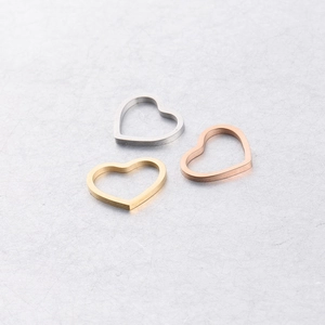 Hollow heart-shaped titanium steel pendants in silver, gold, and rose gold finishes