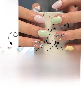 Detail of short round pastel nails with 3D bunny embossments and flower accents