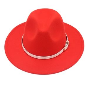 Detail of red wool fedora featuring a white leather belt and golden metal buckle