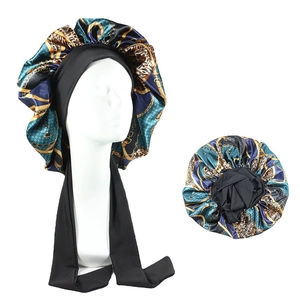 Detail of vintage leopard chain print satin sleep bonnet with long adjustable straps