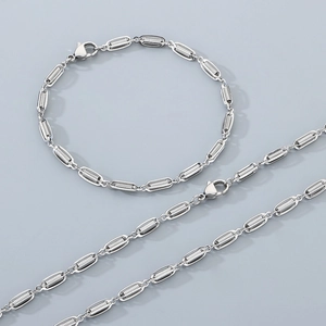Detail of silver stainless steel necklace and bracelet with oval cage link design