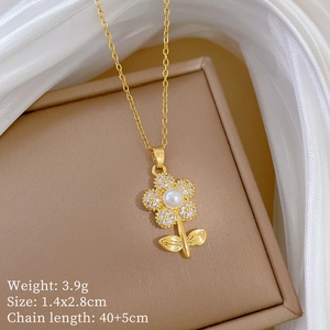 Macro shot of gold flower pendant necklace with pearls and crystals on a brown jewelry box