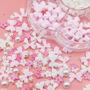 Nail art decoration set with Aurora bows pearls and flowers in a 7-grid storage box