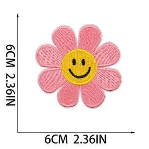 Detail of a 6cm pink flower smiley face embroidered patch showing size measurements